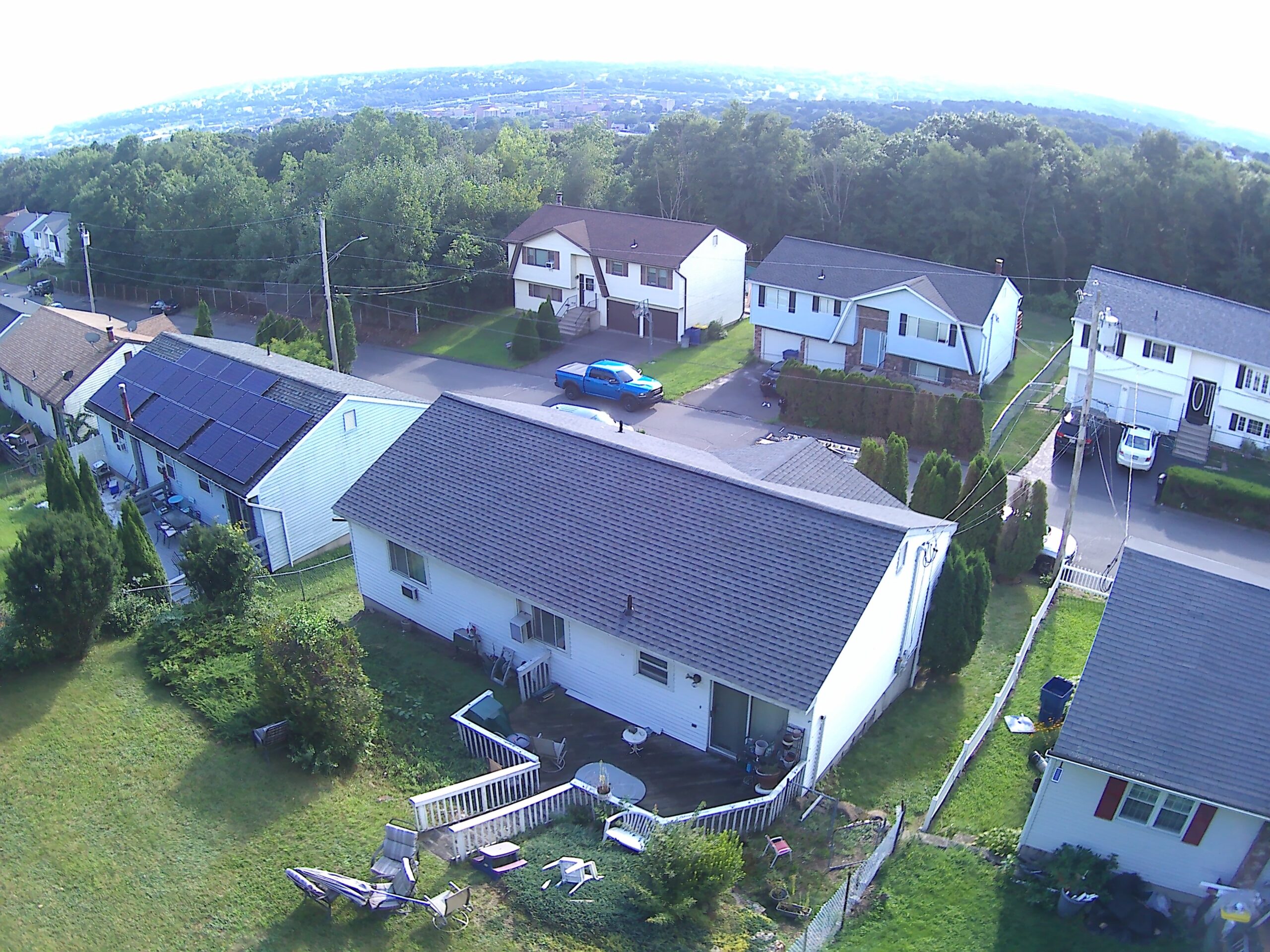 Aerial view of a house with a freshly installed brown asphalt shingle roof